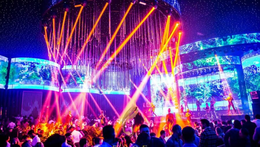 Vibrant nightclub scene, colorful lights, energetic crowd, dynamic performances, social connection.