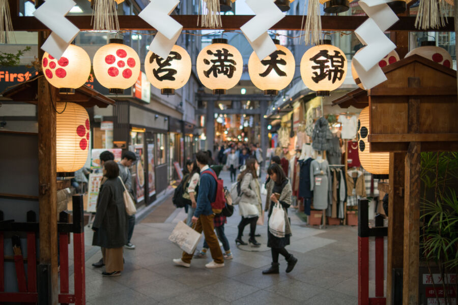 Visitors crowd Nishiki Market in Kyoto, Japan, enjoying the vibrant atmosphere
