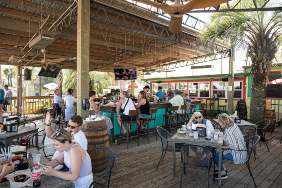 North Beach Bar and Grill on Tybee Island features outdoor seating with tables in the sand for customers to enjoy