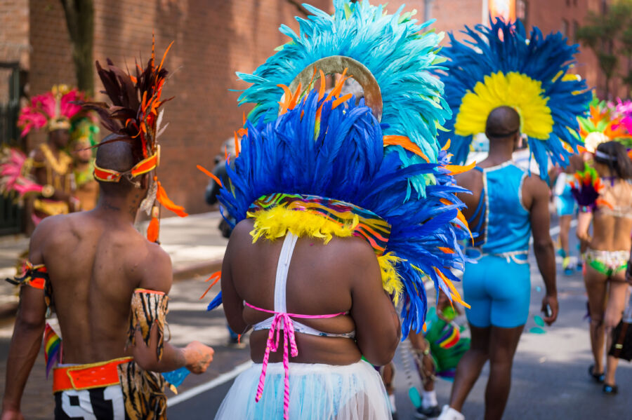 Vibrant scene from Notting Hill Carnival in London, showcasing participants in colorful costumes celebrating together