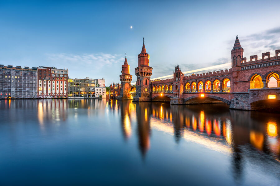 The Oberbaumbrücke bridge spans the River Spree, linking Kreuzberg and Friedrichshain in Berlin, showcasing its distinctive architecture