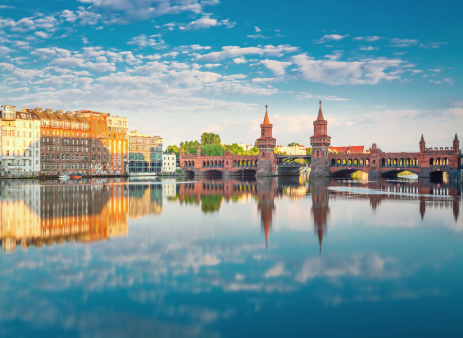 Oberbaumbruecke or the Oberbaum Bridge in Berlin during summer, reflecting on water