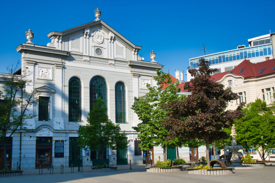 Exterior view of the historic Old Market Hall in Bratislava, showcasing its architectural details and surrounding area