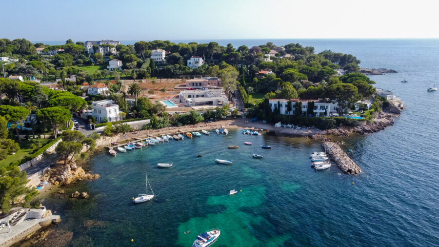 Aerial view of luxury homes near Olivette Port, Cap d'Antibes, with leisure boats in the Mediterranean Sea, South of France