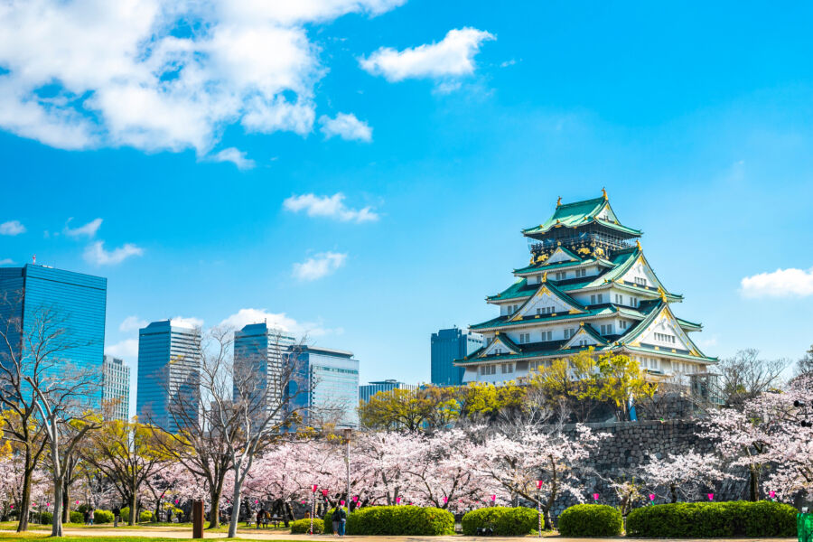 Osaka Castle stands majestically against the skyline of Osaka, Japan, showcasing its historical architecture and urban backdrop