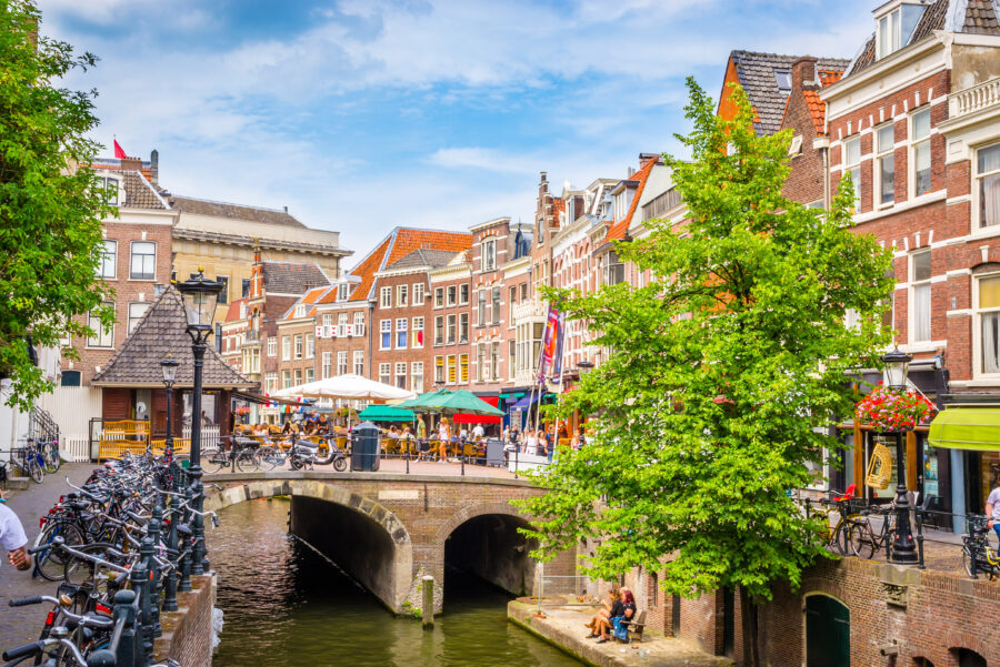 Scenic view of traditional houses on the Oudegracht canal in Utrecht, Netherlands, highlighting the city's rich history