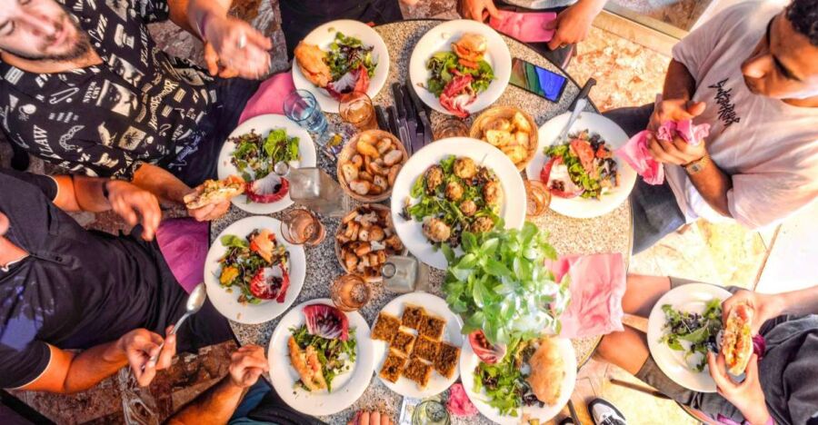 Family and friends enjoy a shared meal outdoors in Lyon, France
