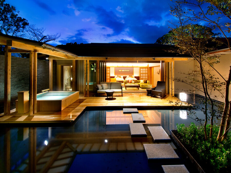 Modern wooden home by water, blending nature with luxury living and serene outdoor spaces.