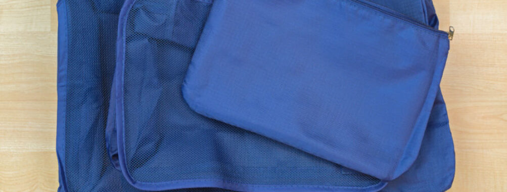 Set of blue cube bags for travel organization, featuring multiple designs to enhance packing efficiency and convenience