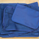 Set of blue cube bags for travel organization, featuring multiple designs to enhance packing efficiency and convenience