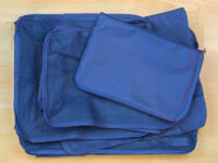 Set of blue cube bags for travel organization, featuring multiple designs to enhance packing efficiency and convenience