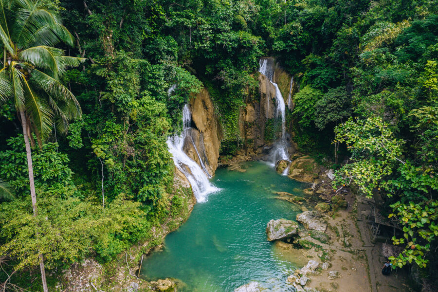 Aerial view of Pahangog Falls on Bohol Island, showcasing cascading water surrounded by lush greenery