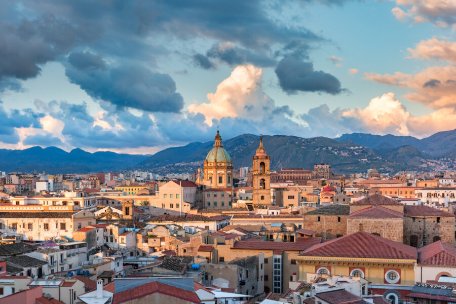 Sunset over Palermo, Sicily, showcasing vibrant colors illuminating the cityscape and historic architecture