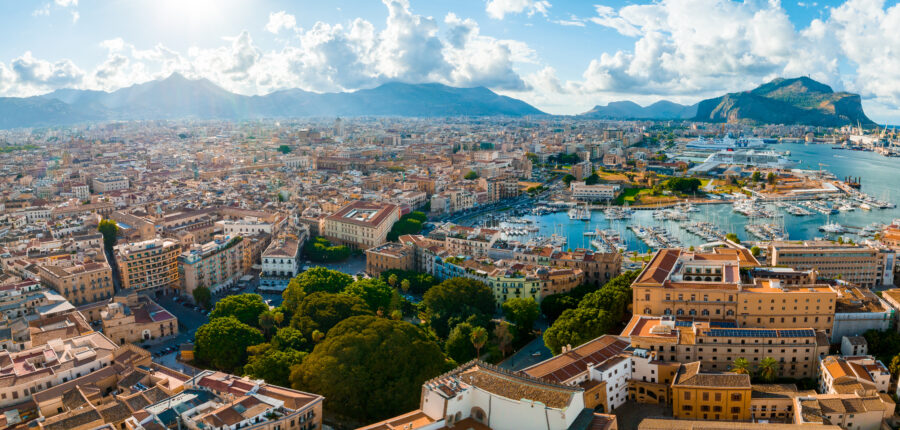 Panoramic aerial view of Palermo, Sicily, highlighting the town and the nearby white sand beach and lagoon