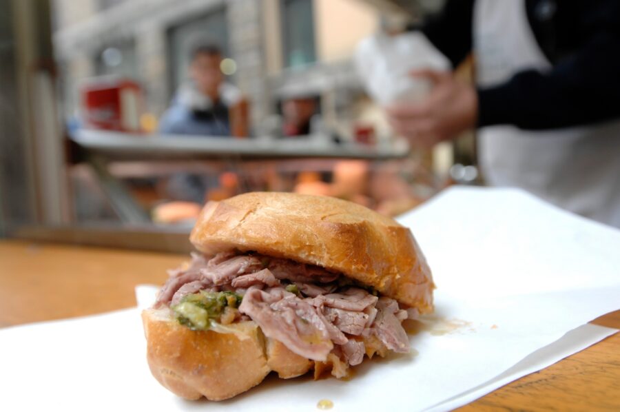 Lampredotto sandwich featuring stewed cow's stomach in tomato sauce, a popular street food in Florence, Tuscany