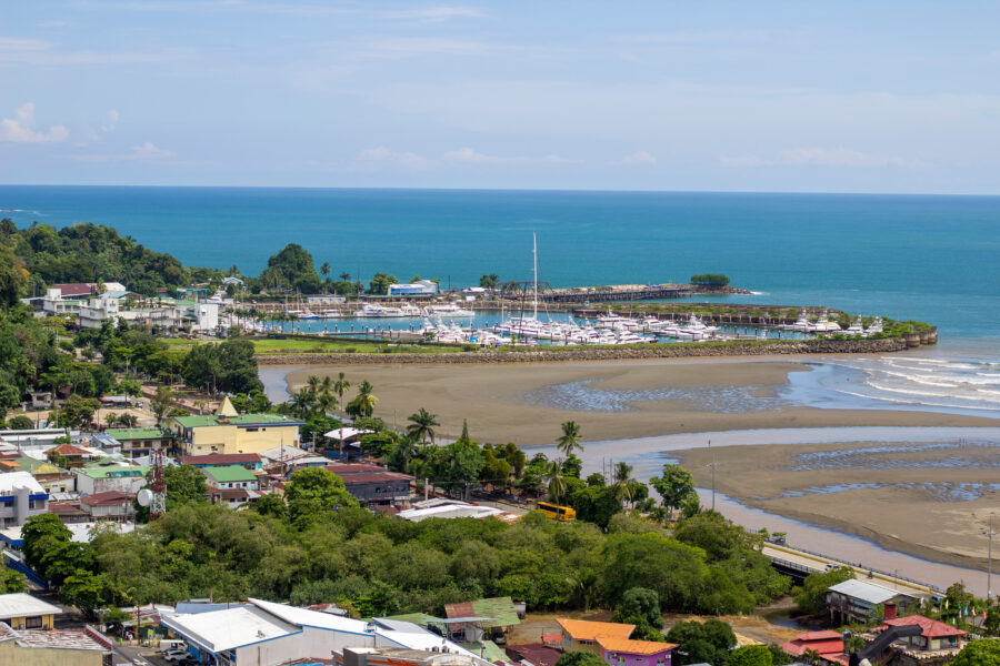 Scenic vista from a viewpoint in Quepos, featuring Marina Pez Vela and various structures of the canton in the background