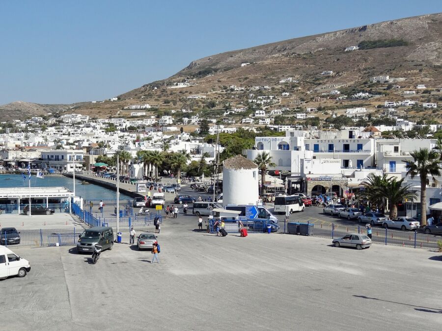 The Parian Boutique Hotel features a white house with a cozy patio and stylish furniture, perfect for relaxation in Greece.
