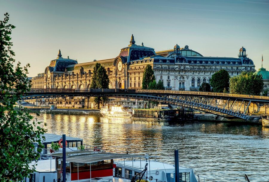 Musée dOrsay in morning light, Paris, with Seine River reflections and Passerelle Léopold-Sédar-Senghor.