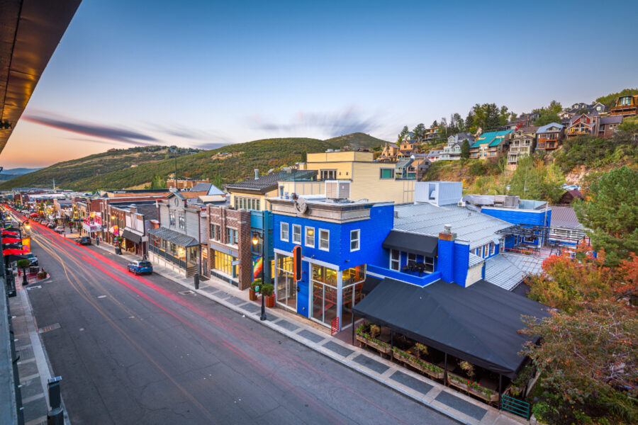 Scenic view of Main Street in Park City, Utah, featuring quaint buildings and a backdrop of majestic mountains