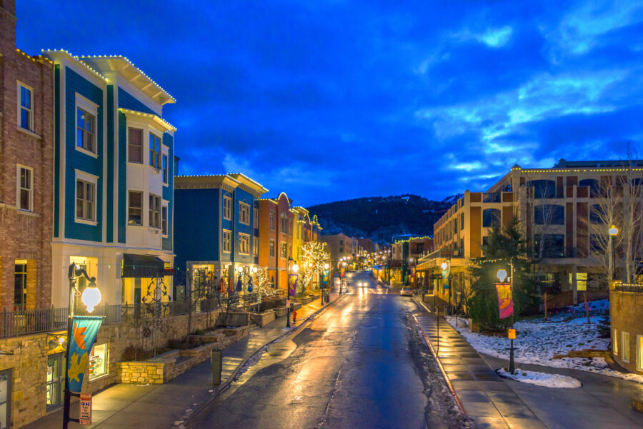Park City, Utah street scene at night, showcasing softly lit buildings and a peaceful, snowy environment