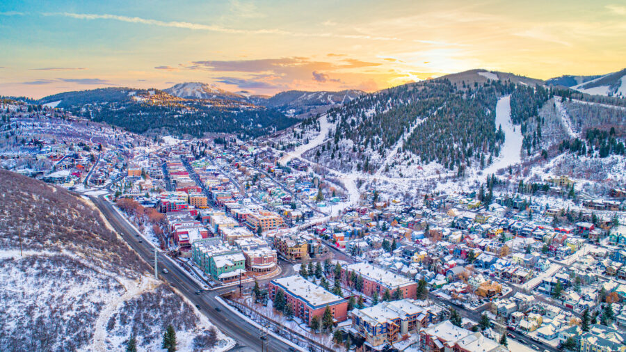 Aerial view of Downtown Park City, Utah, blanketed in snow, showcasing the skyline and winter landscape