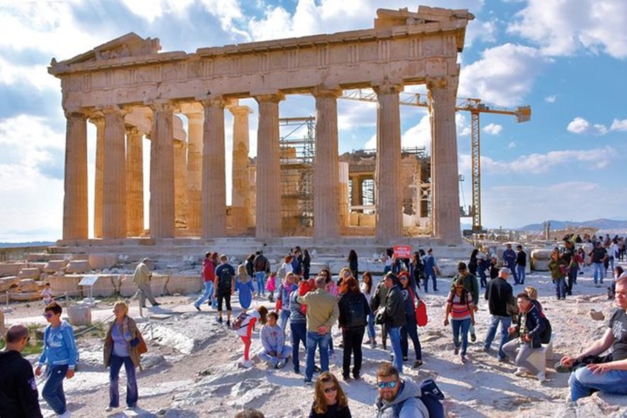 Tourists enjoy the historic Parthenon amid restoration, blending ancient marvels with modern preservation.
