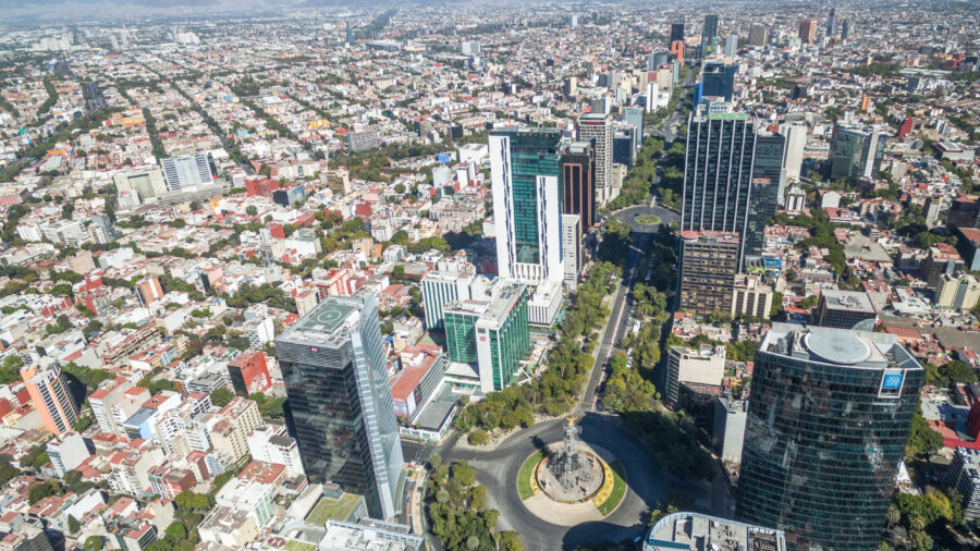 Aerial view of Paseo De La Reforma Avenue in Mexico City, showcasing its wide lanes and surrounding urban landscape