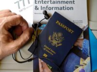 Travel preparation with US passport, earphones, and entertainment magazine on plane.