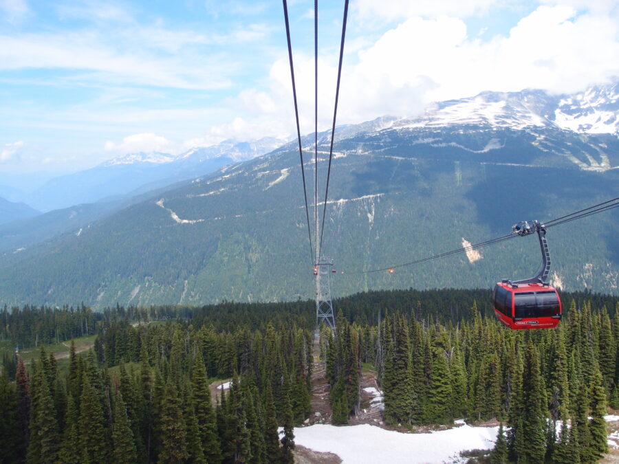 The PEAK 2 PEAK Gondola transports a cable car up Whistler Mountain, showcasing breathtaking alpine scenery.
