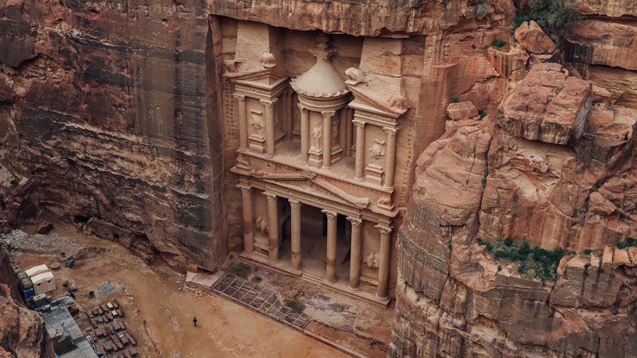 Ancient rock-cut temple facade at Petra in Jordan, sandstone cliff architecture with columns.