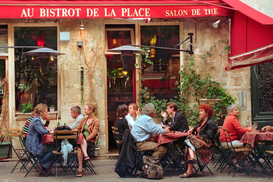 People Sitting Outside the Bistro while Having Conversation