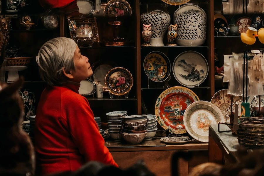 A woman looking at a display of plates and bowls