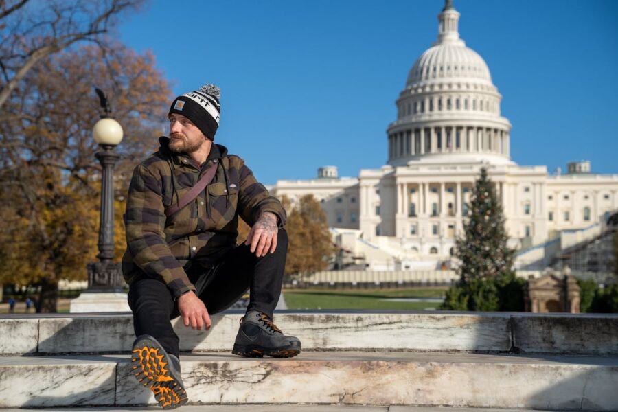 Man Posing in Front of the US Capitol Building