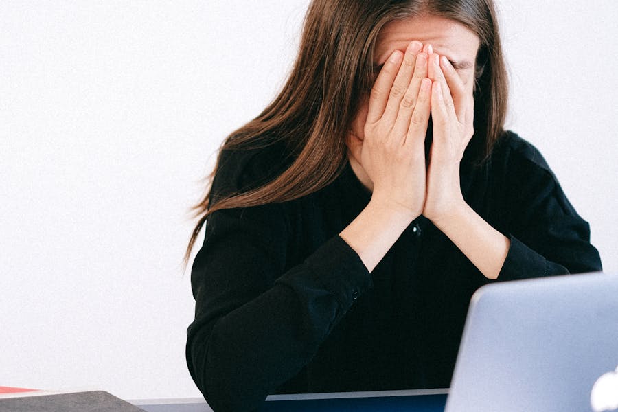 Unemployed Woman Covering her Face with her Hands