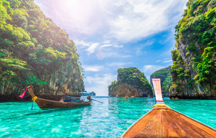 Scenic view of Loh Samah Bay on Phi Phi Island, Thailand, showcasing turquoise waters and lush green cliffs
