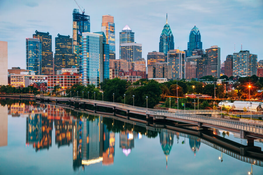 The skyline glows under the Philadelphia, Pennsylvania night sky, conveying the city's vibrancy