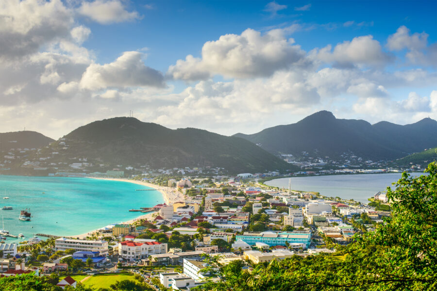 Cityscape of Philipsburg, Sint Maarten, featuring buildings along the Great Salt Pond under a clear blue sky.