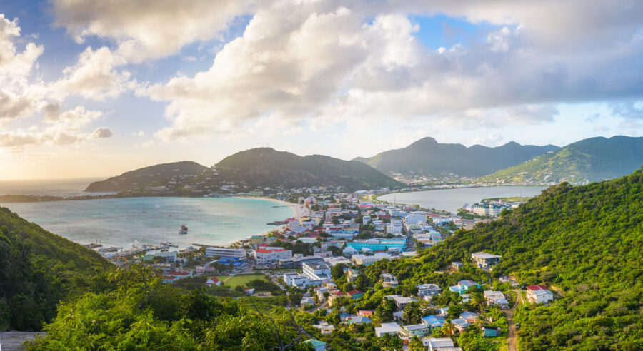 Scenic view of Philipsburg, Sint Maarten, showcasing the Great Salt Pond and the vibrant city skyline