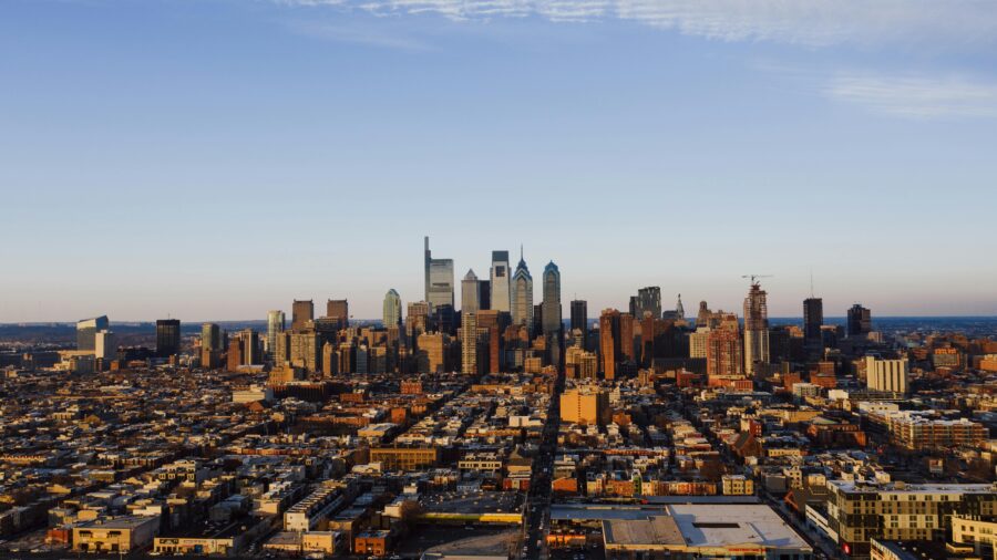 Aerial view of Philadelphias skyline at sunset, showcasing diverse architecture and cityscape.