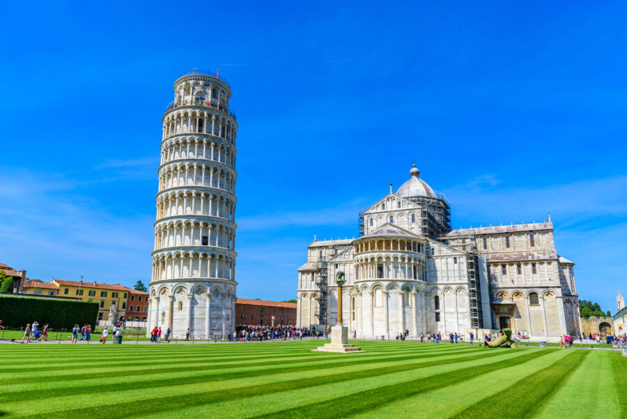 Pisa Cathedral and the Leaning Tower of Pisa stand majestically in Piazza dei Miracoli, a renowned tourist destination in Tuscany