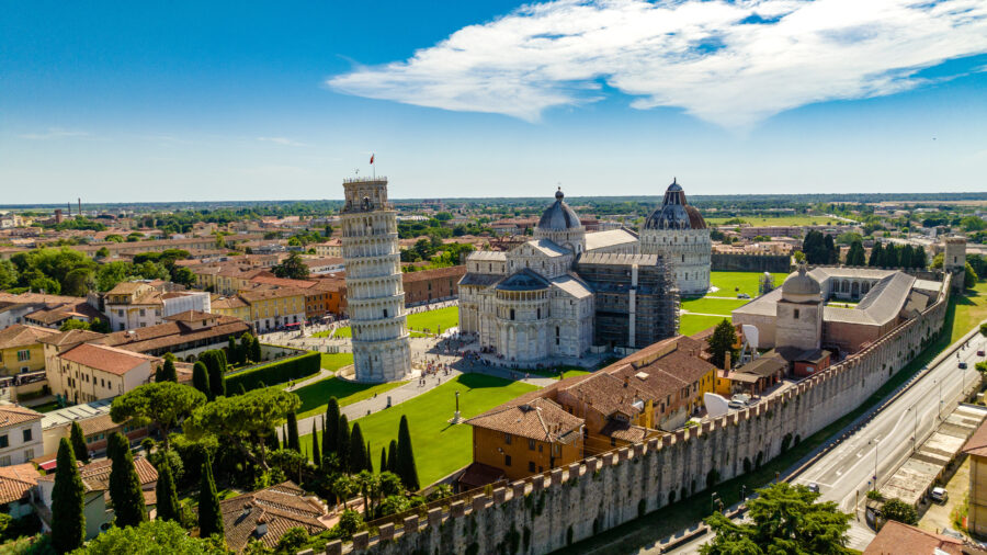 Aerial view of the Leaning Tower of Pisa and Piazza del Duomo on a sunny day in Italy