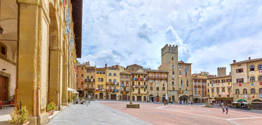 Scenic view of Arezzo's Piazza Grande, featuring charming buildings and lively public space in Tuscany, Italy
