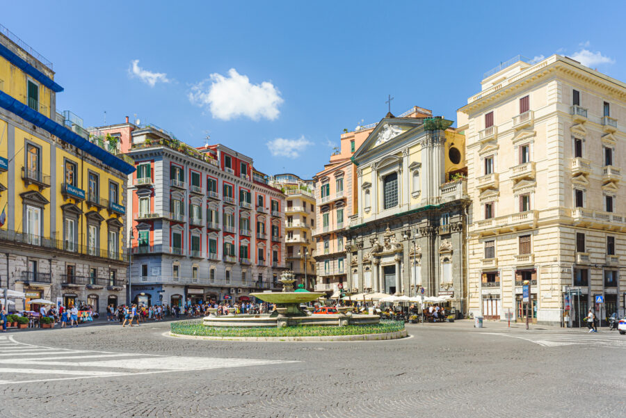 Piazza Trieste e Trento in Naples on a bright August day, with the Artichoke Fountain in front of San Ferdinando Church