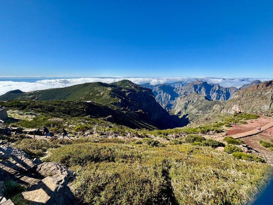 Scenic vista from Pico do Arieiro in Madeira, featuring a mountain summit enveloped in clouds.
