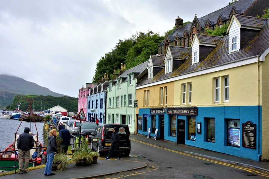 Charming coastal town with colorful buildings and moored boats along the waterfront.