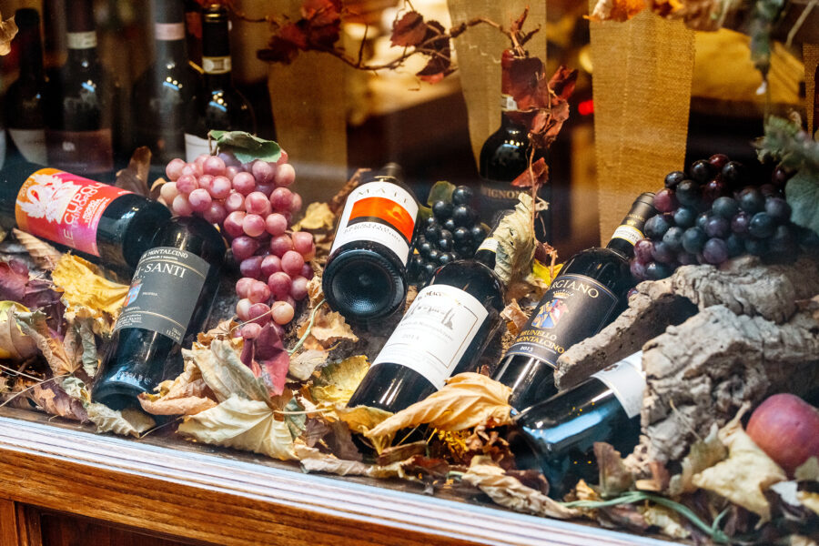 Montalcino wines displayed for sale at a local market in Pienza, Tuscany, showcasing the region's renowned wine culture