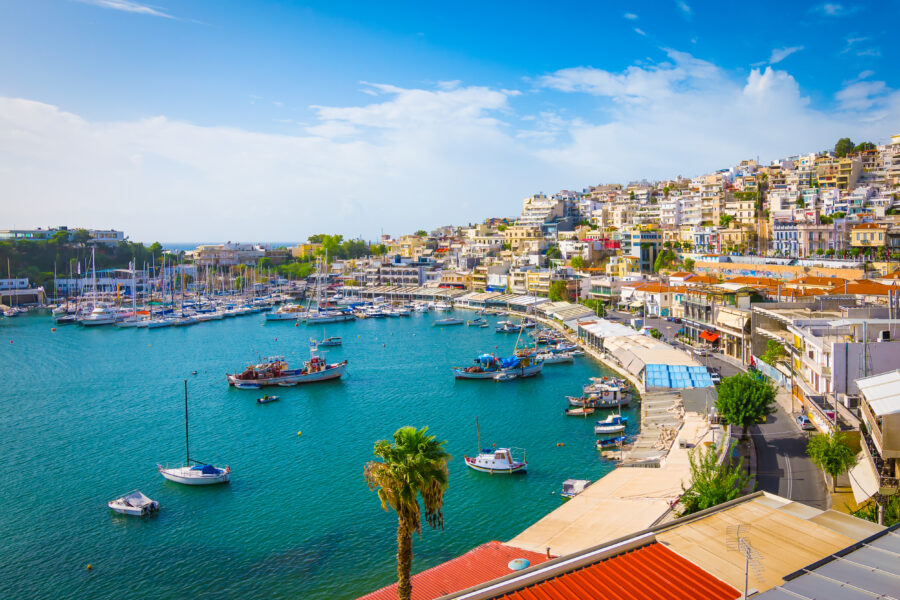 Scenic view of Mikrolimano harbour in Piraeus, Athens, showcasing a bustling yacht marina and surrounding waterfront