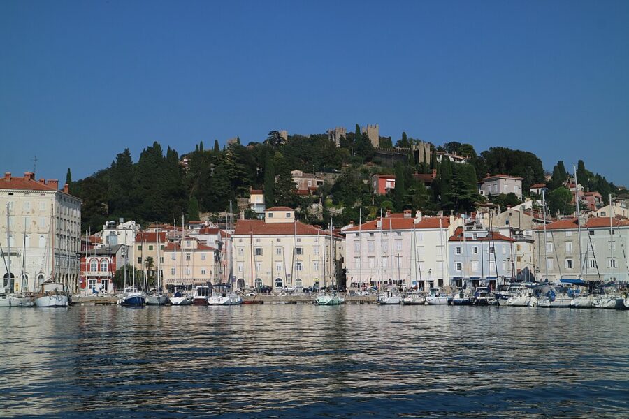 Scenic Piran Harbour in Slovenia, showcasing a tranquil body of water dotted with a few boats.