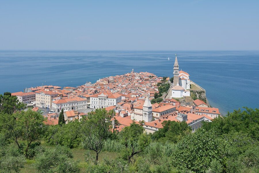 Scenic view of Piran's charming old town in Slovenia, featuring historic buildings and a coastal backdrop.
