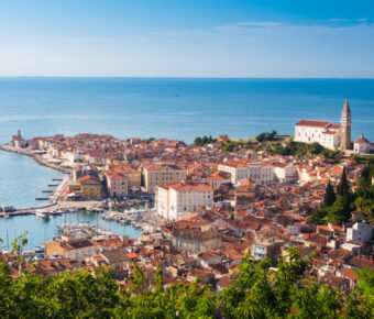 Scenic view of Piran's charming old town in Slovenia, featuring historic buildings and a coastal backdrop.